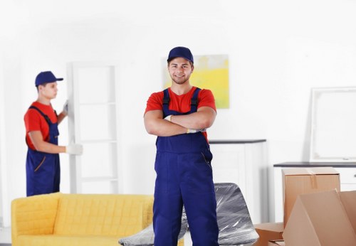 Relocation team carrying a large sofa through a doorway
